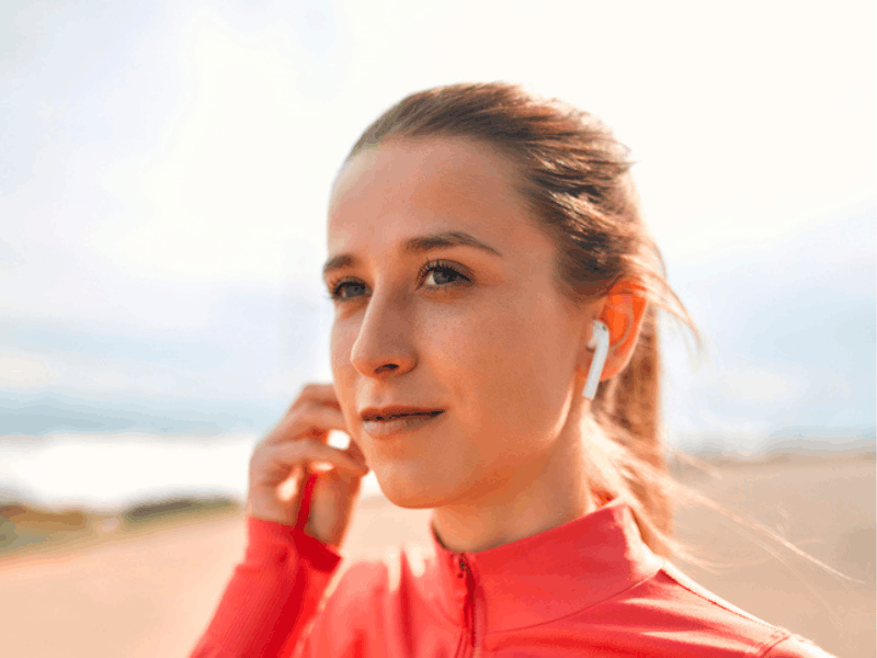 woman in sportswear listening to music