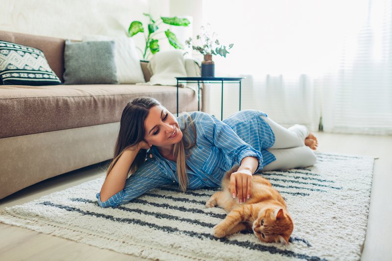 Woman playing with cat