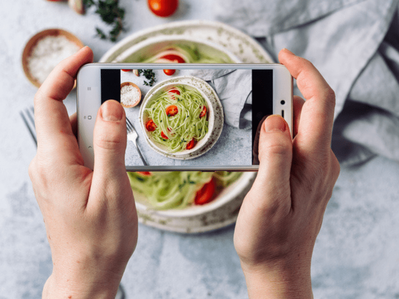 Woman takes picture of food