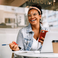 Woman works on a laptop in a coffee shop