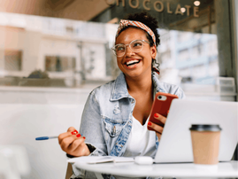Woman works on a laptop in a coffee shop