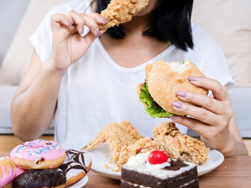 Woman eating too much food