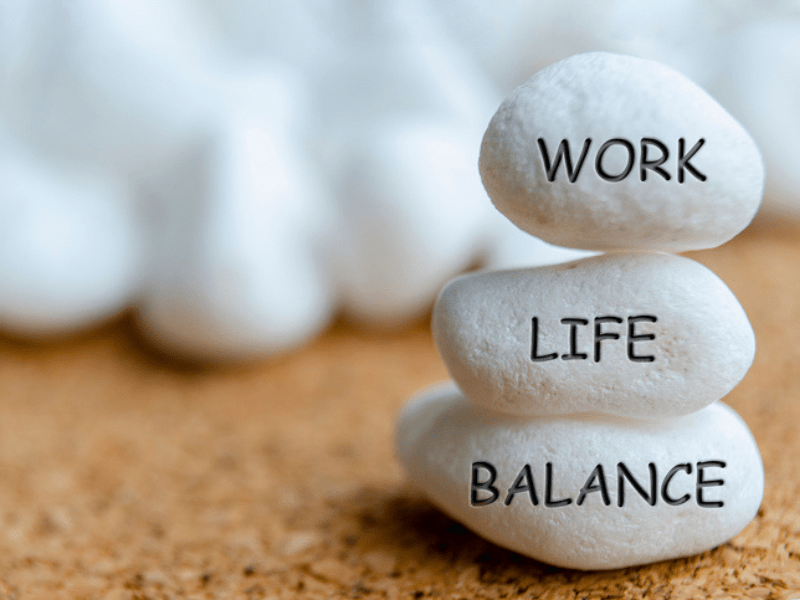 white stones with work, life, balance engraving