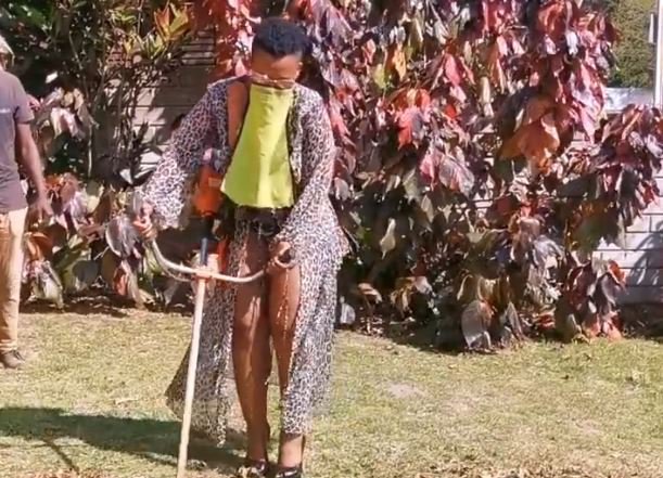 Zodwa Wabantu cutting the grass in heels